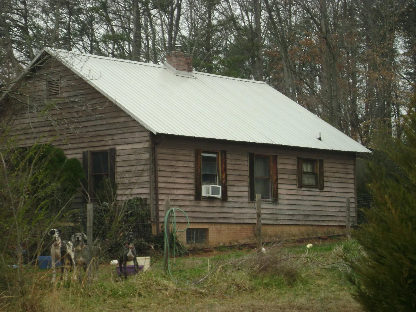 White metal roof on an old wood sided farmhouse, from a Metal Roof Installation job in Henning